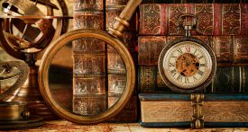 Magnifying glass, pocket watch and old books